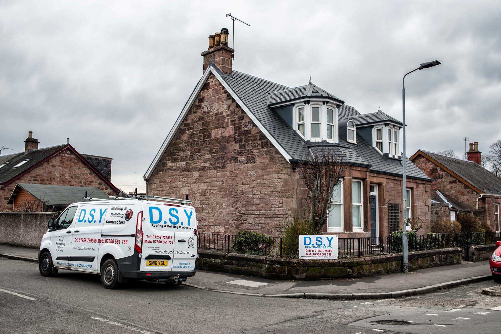DSY van parked outside house with new roof